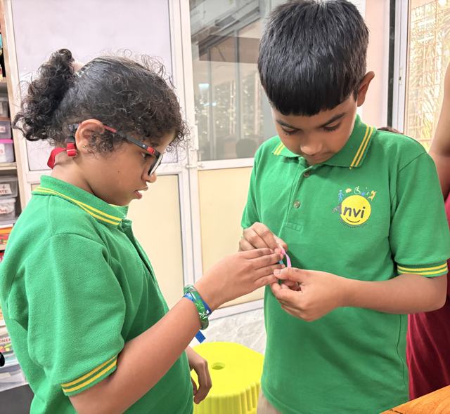 Tying friendship bands on Friendship Day