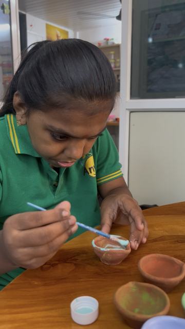 Decorating diyas for Diwali