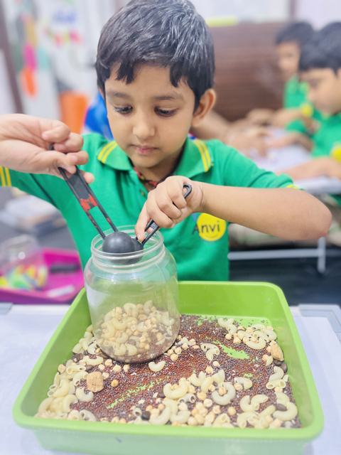 Scooping grains into a jar — focus and fine-motor control